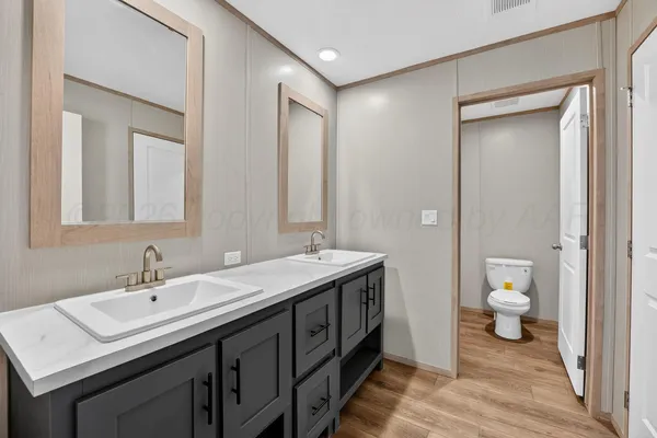 a spacious bathroom with a double vanity sink and a mirror