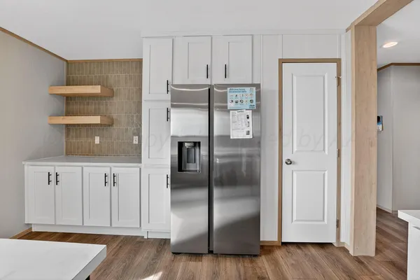 a kitchen with stainless steel appliances a refrigerator and cabinets