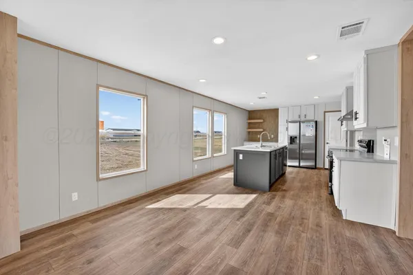 a view of a kitchen with a sink and wooden floor