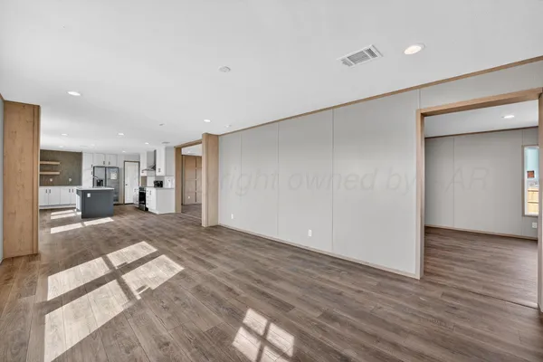 a view of a big room with wooden floor and a bathroom