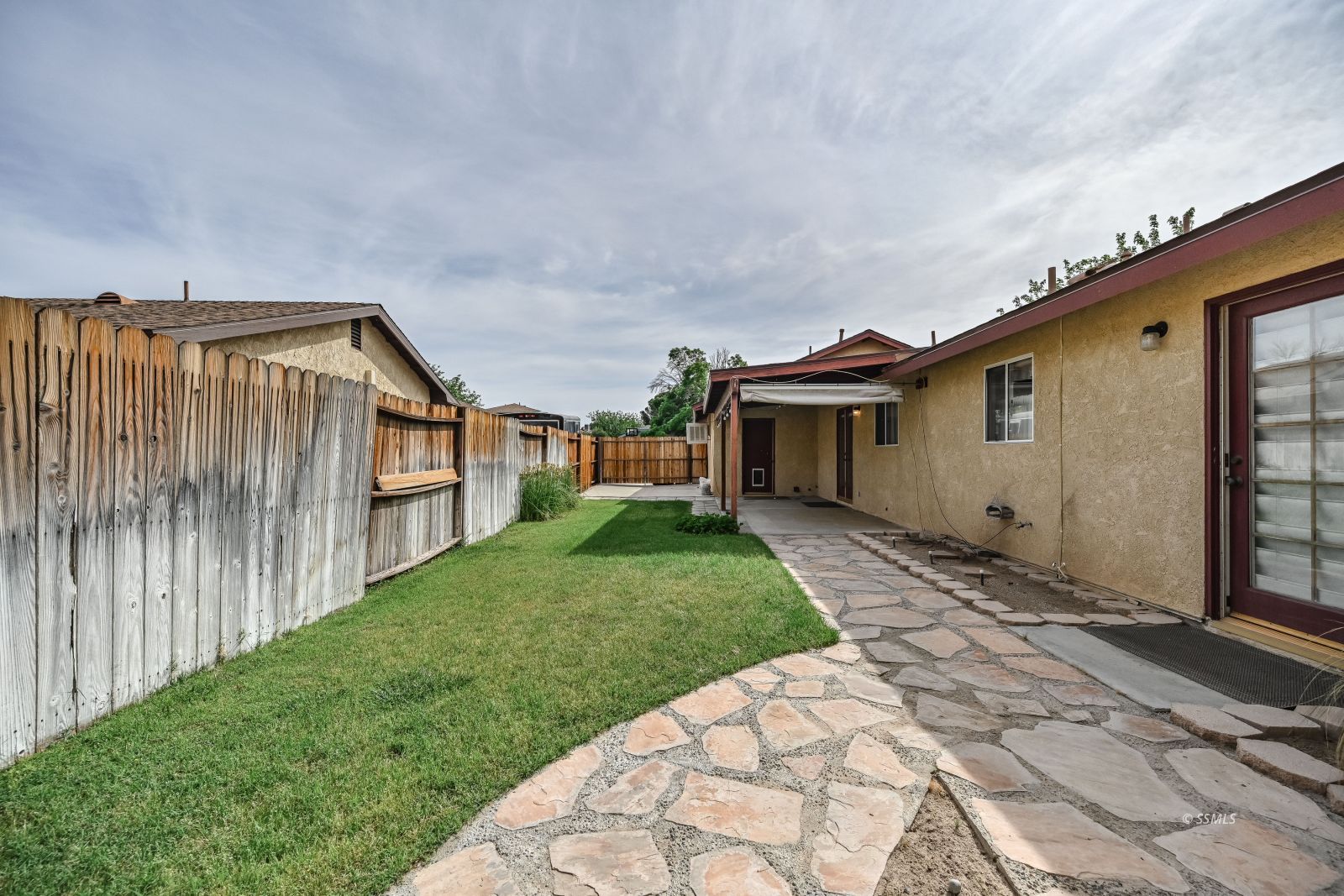 131 Chambers Street Ridgecrest, CA 93555 - Photo 27 of 28 a view of a house with a yard and pathway
