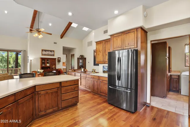 a kitchen with refrigerator and cabinets