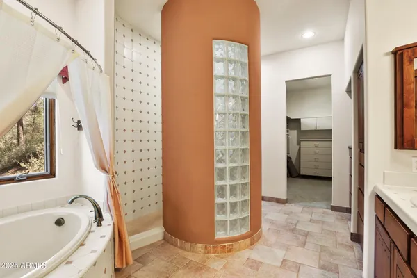 a bathroom with a bathtub and a shower