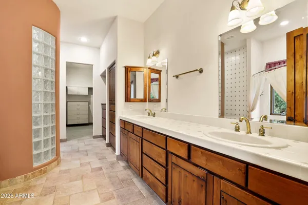 a spacious bathroom with a double vanity sink a and a mirror