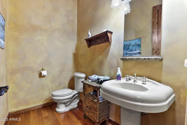 a bathroom with a sink toilet and a mirror