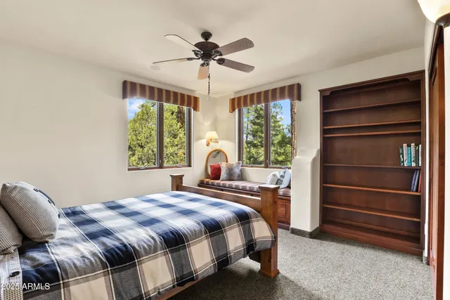 a bed sitting in a bedroom next to a window