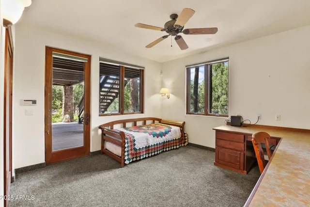 a bedroom with a bed a chandelier and a window