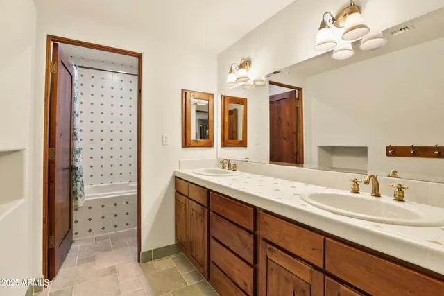 a bathroom with a sink a double vanity and a mirror