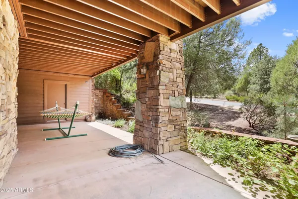 a view of an outdoor space with wooden roof and sitting space