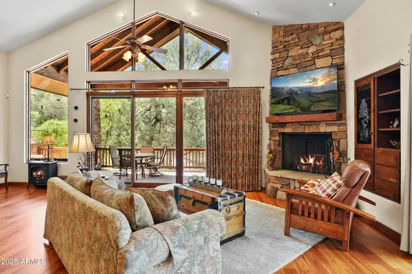 a living room with furniture a fireplace and a large window