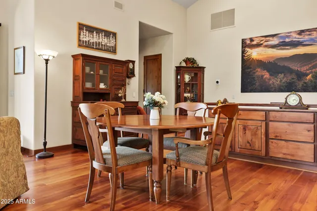 a dining room with furniture and wooden floor