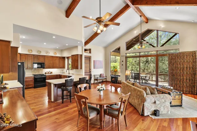 a dining room with furniture a large window and a chandelier