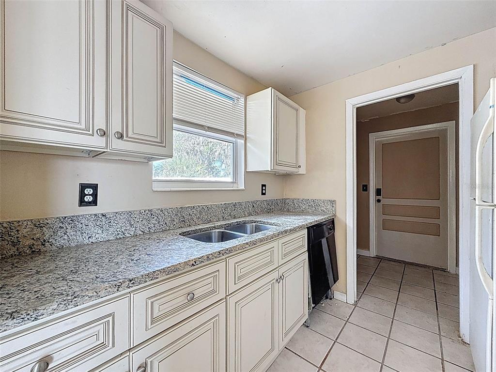 9381 Marler Road Spring Hill, FL 34608 - Photo 14 of 52 a kitchen with granite countertop a sink and a stove