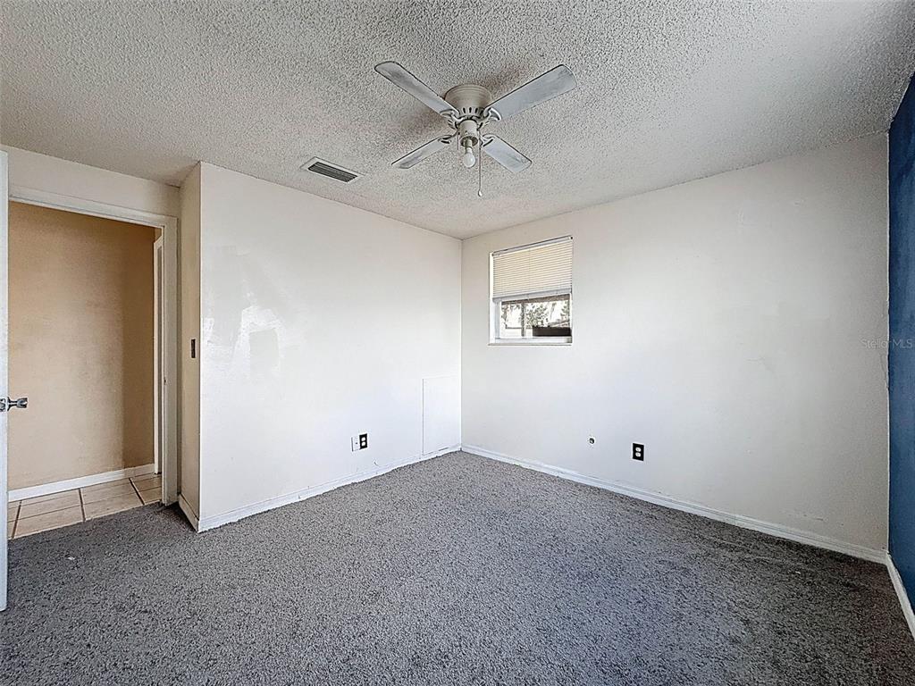 9381 Marler Road Spring Hill, FL 34608 - Photo 21 of 52 an empty room with a ceiling fan and a window