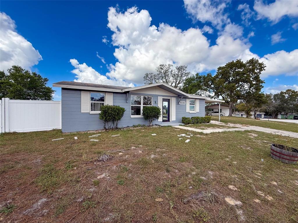 9381 Marler Road Spring Hill, FL 34608 - Photo 33 of 52 a front view of a house with garden