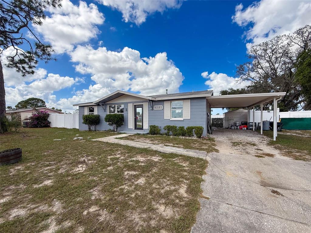 9381 Marler Road Spring Hill, FL 34608 - Photo 37 of 52 a front view of a house with garden