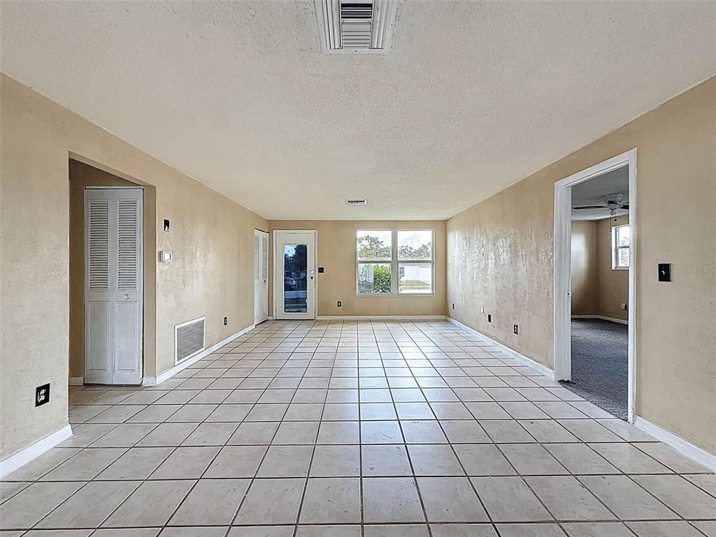 9381 Marler Road Spring Hill, FL 34608 - Photo 7 of 52 a view of empty room with window and wooden floor