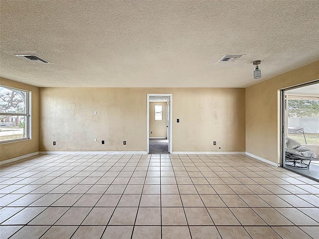 9381 Marler Road Spring Hill, FL 34608 - Photo 9 of 52 a view of an empty room with window and a kitchen