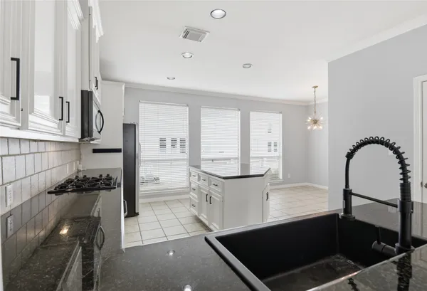 a kitchen with stainless steel appliances granite countertop a stove and a refrigerator