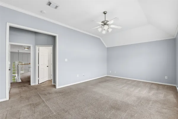 an empty room with fan and entrance