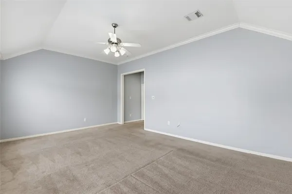 an empty room with a window and a ceiling fan