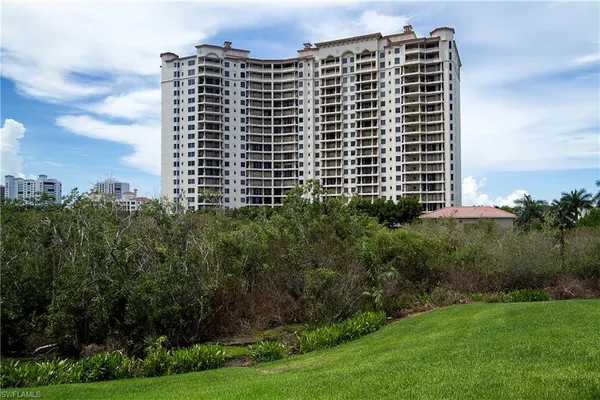 a front view of a building with a yard