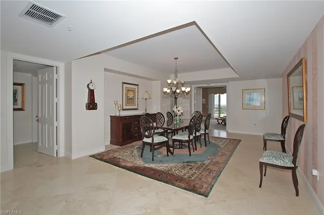 a view of a dining room with furniture and chandelier