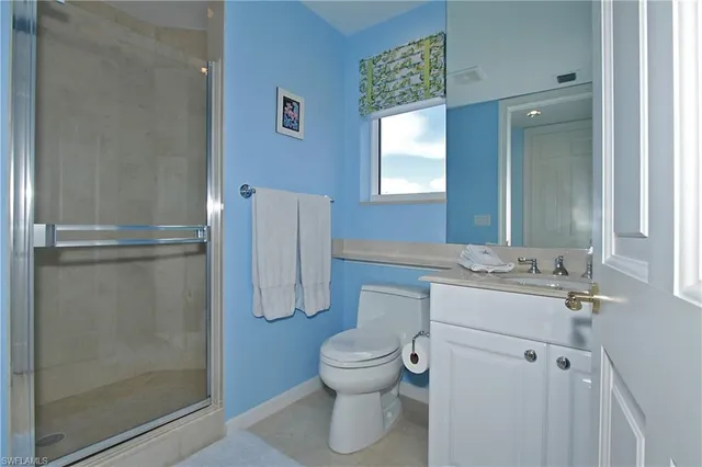 a bathroom with a toilet sink and shower