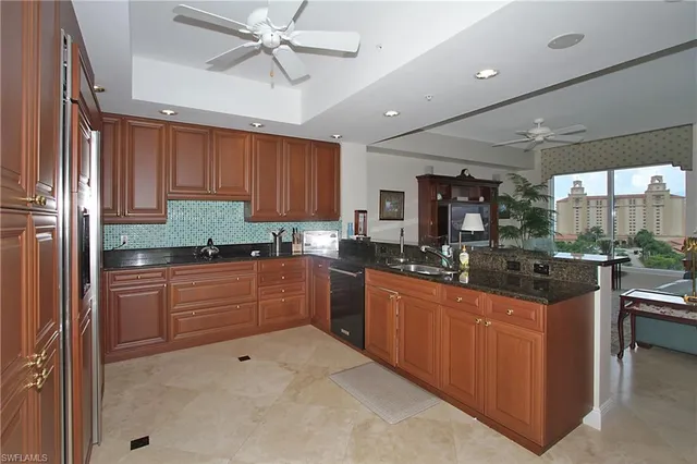 a kitchen with stainless steel appliances granite countertop a sink counter space cabinets and a large window