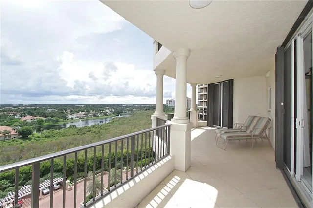 a view of a balcony with chair and city view