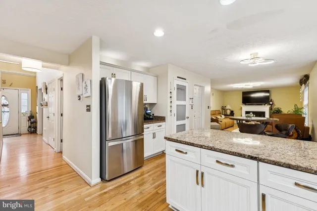 a kitchen with granite countertop a refrigerator and a sink