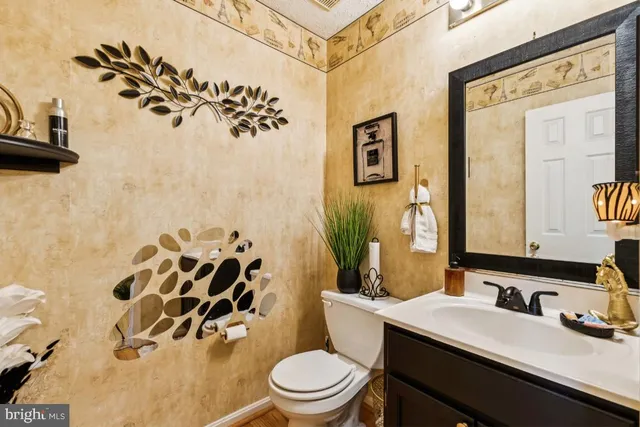 a bathroom with a sink mirror vanity and toilet