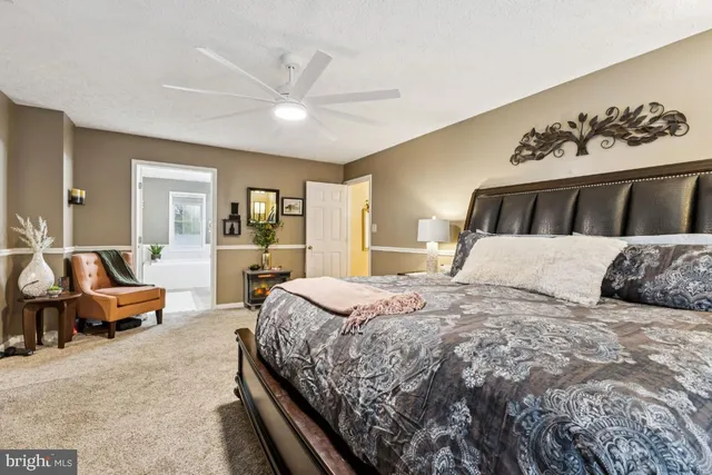 a bedroom with a large bed and a couch