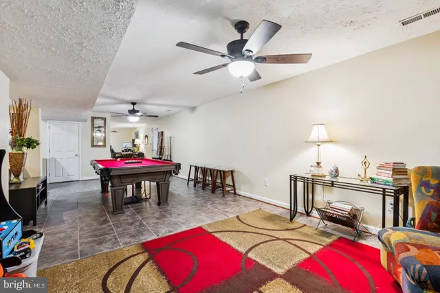 a living room with furniture a rug and a chandelier
