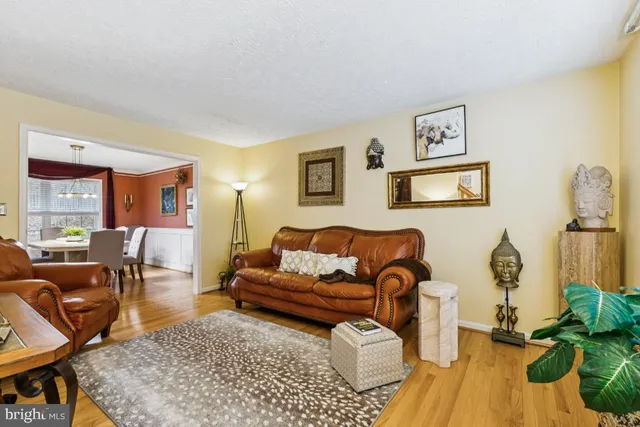 a living room with furniture rug and wooden floor