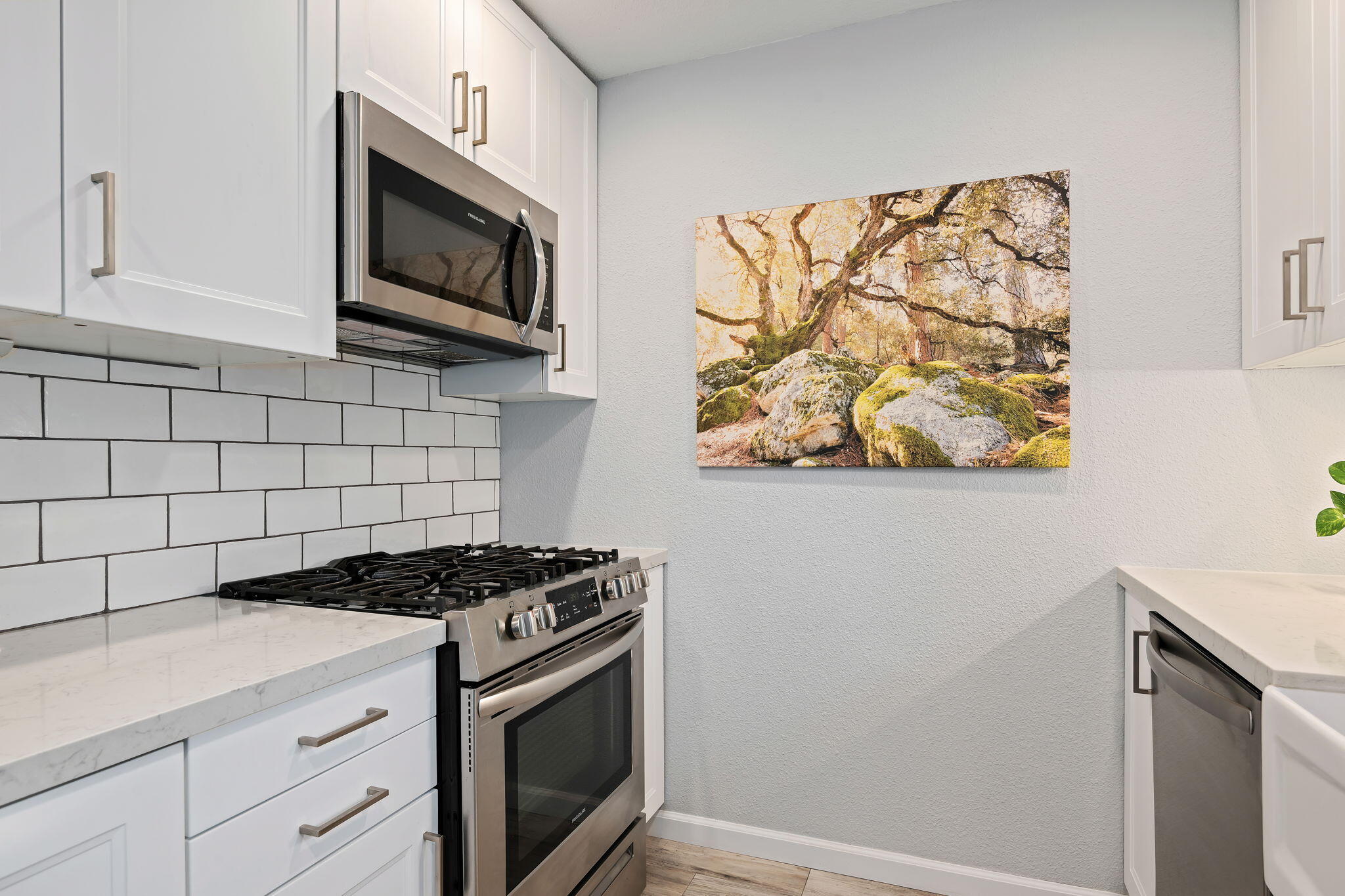 5290 Overpass Road, Unit 10 Goleta, CA 93111 - Photo 11 of 26 a kitchen with stainless steel appliances a white cabinet and a stove top oven