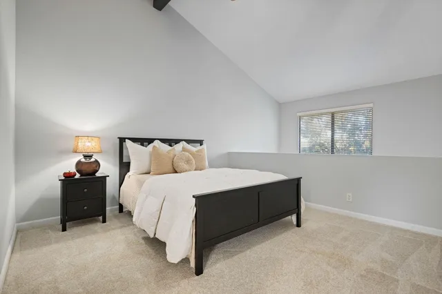 a spacious bedroom with a bed and window