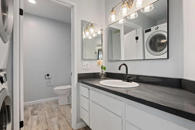 a bathroom with a granite countertop sink and a mirror