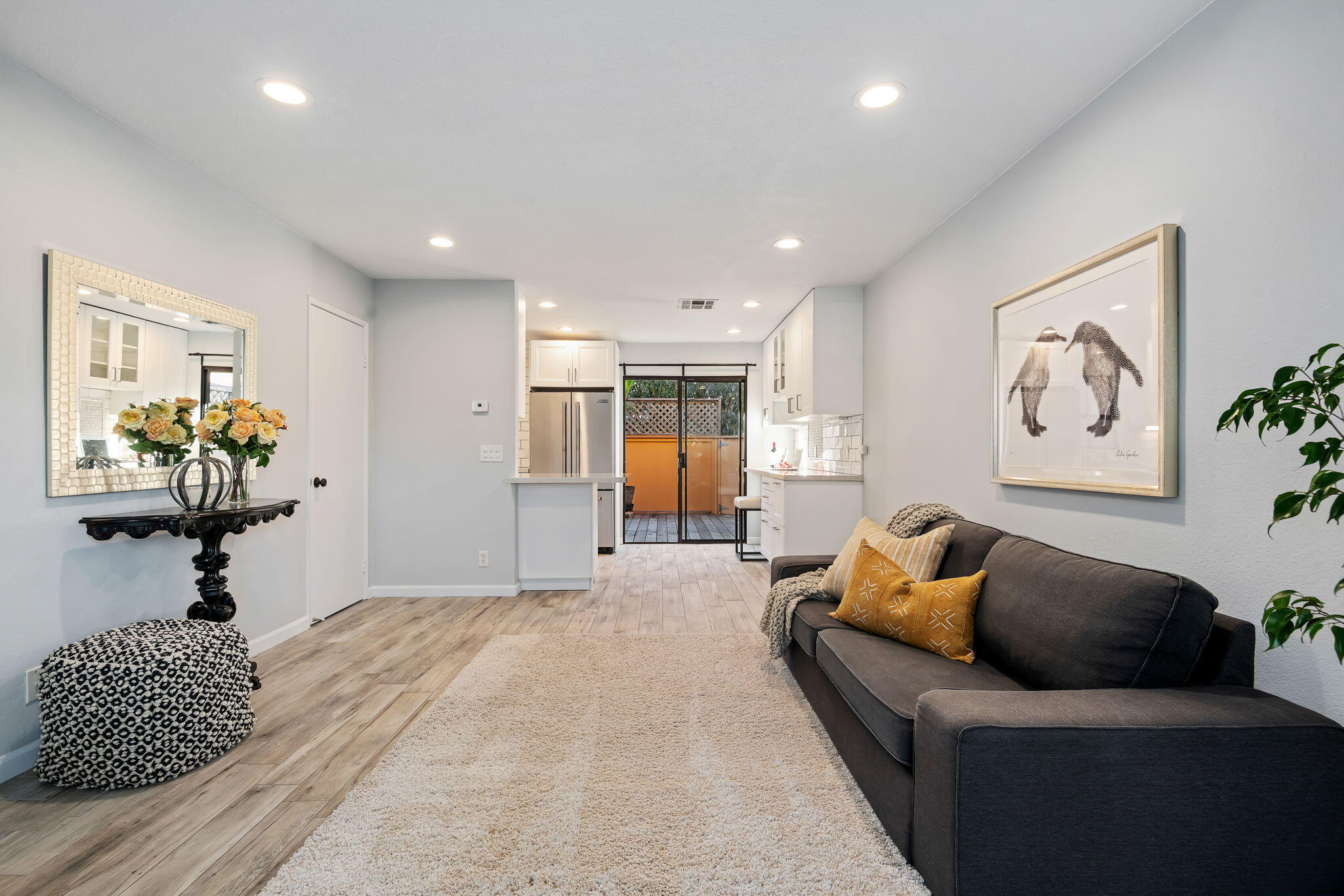 5290 Overpass Road, Unit 10 Goleta, CA 93111 - Photo 3 of 26 a bedroom with a bed and a chandelier