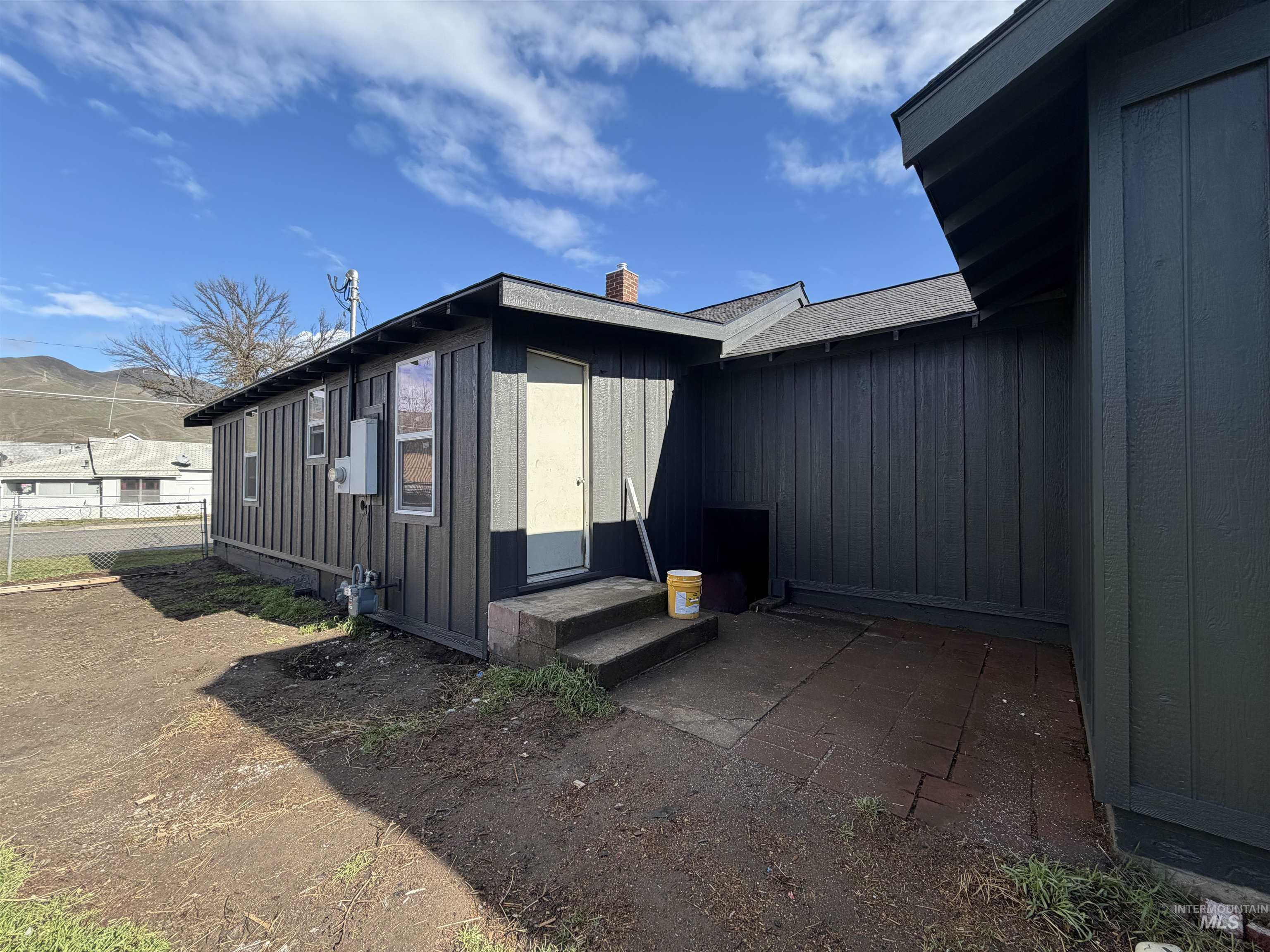 600 11th Street Clarkston, WA 99403 - Photo 12 of 27 View of side of home with a chimney, entry steps, and board and batten siding
