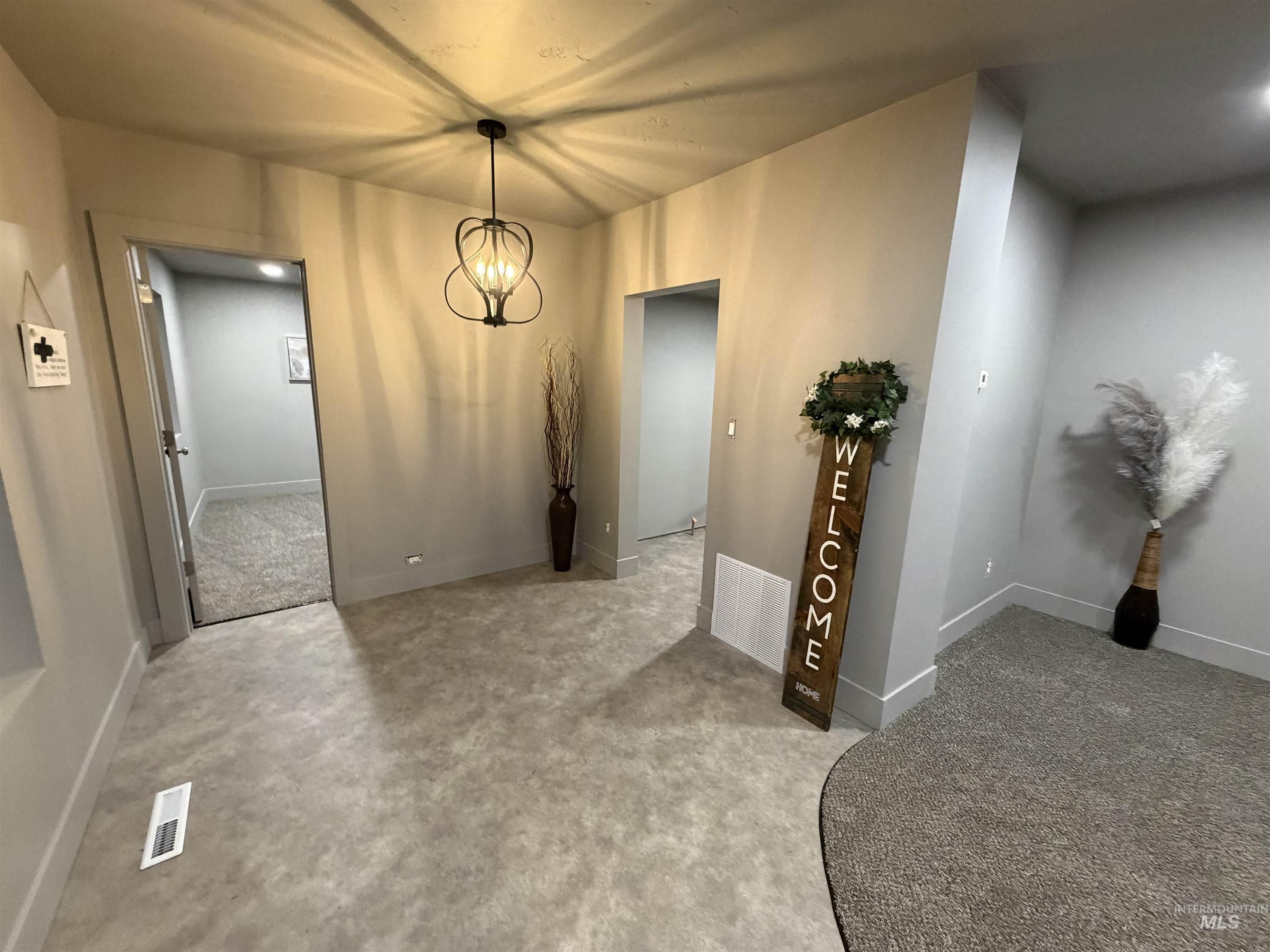 600 11th Street Clarkston, WA 99403 - Photo 15 of 27 Unfurnished dining area featuring a chandelier and light carpet