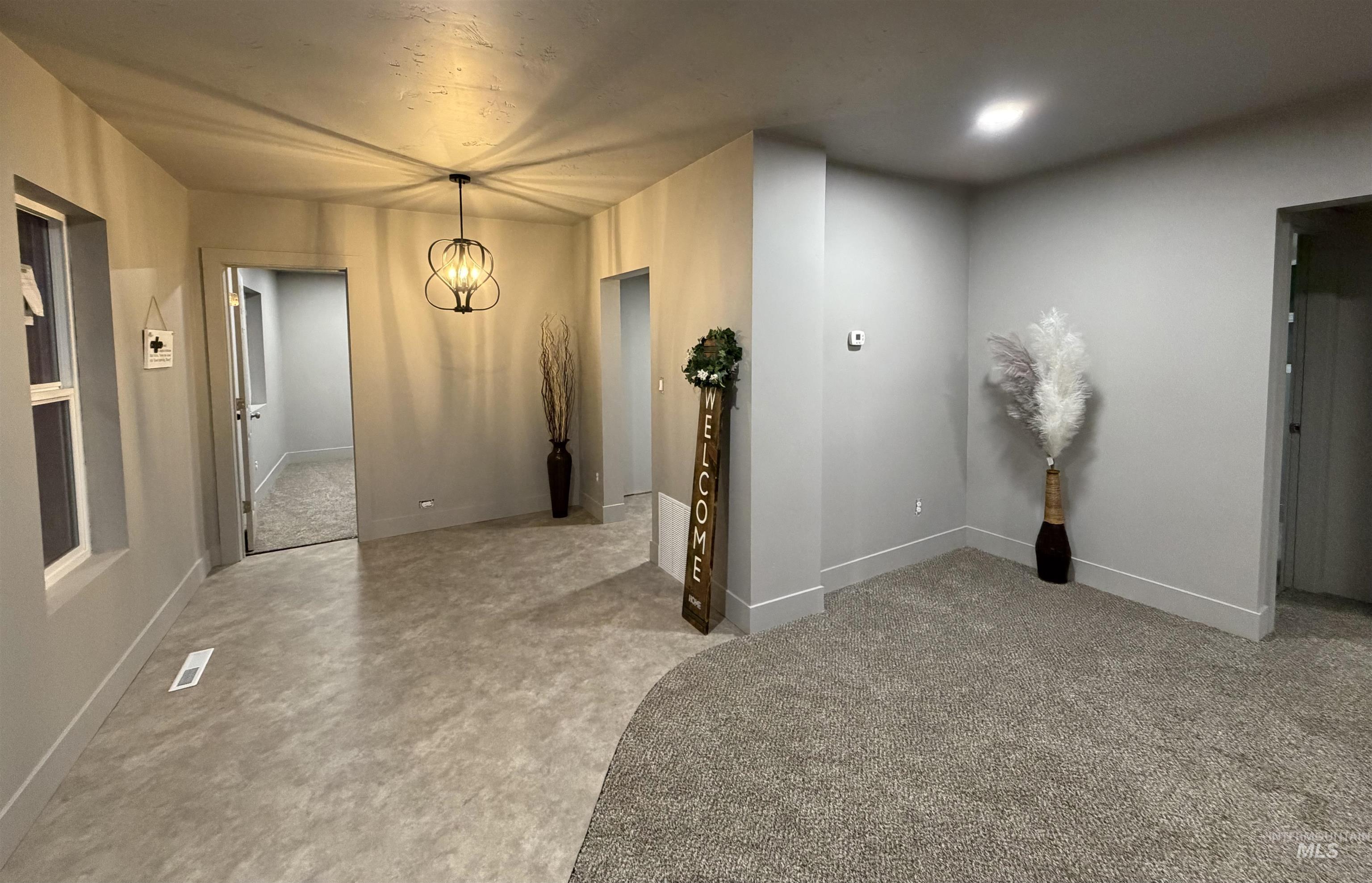 600 11th Street Clarkston, WA 99403 - Photo 19 of 27 Hallway featuring hanging lights and light colored carpet