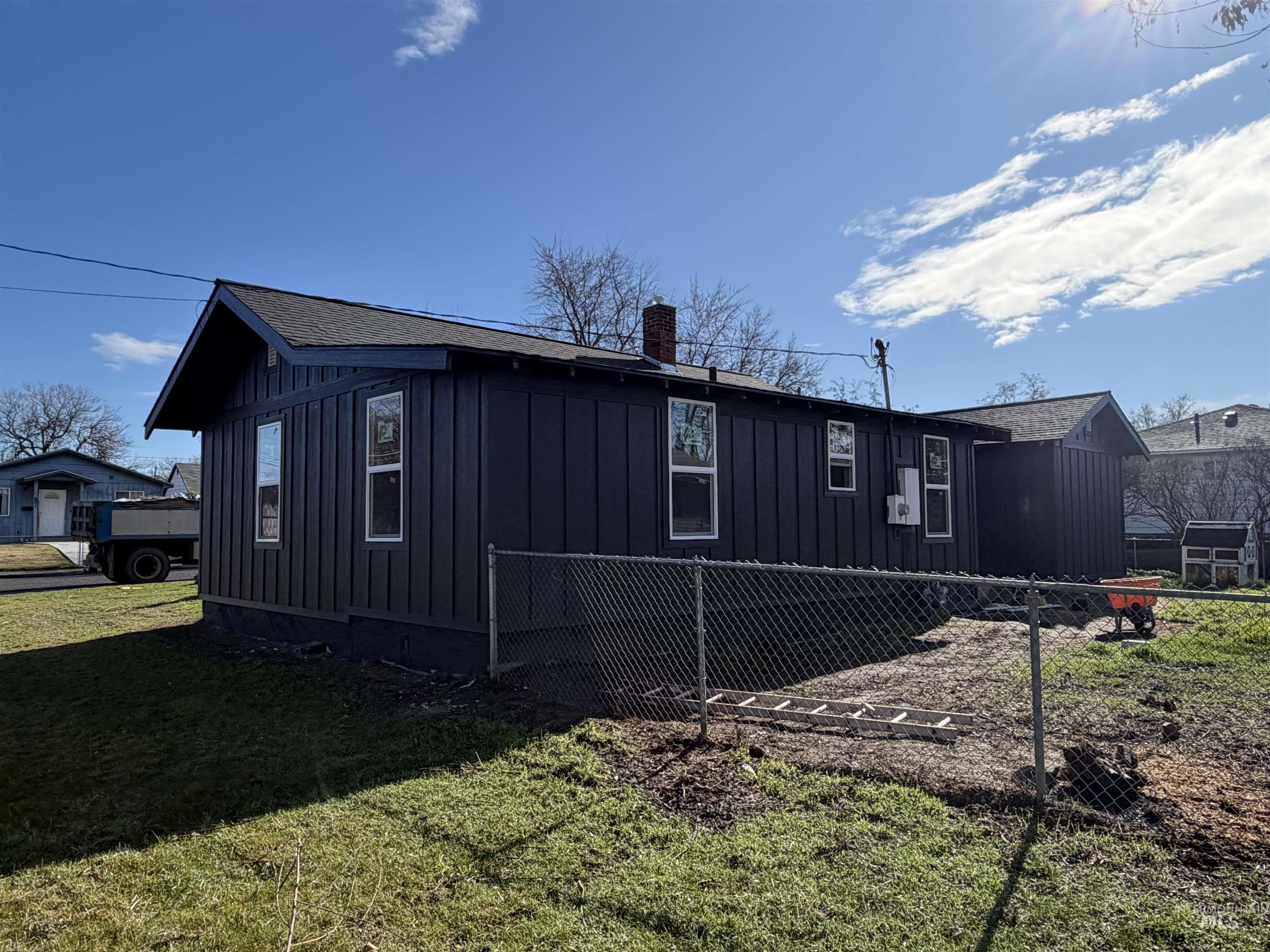 600 11th Street Clarkston, WA 99403 - Photo 8 of 27 View of home's exterior with board and batten siding, a chimney, and roof with shingles