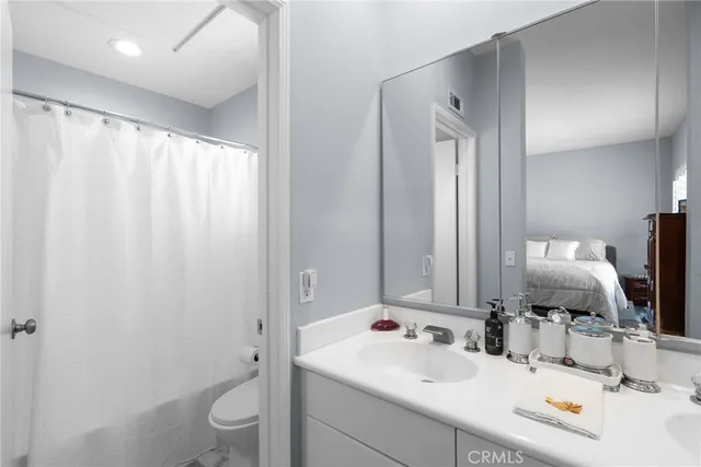 a bathroom with a sink vanity mirror and toilet