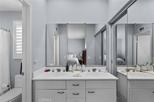 a bathroom with a double vanity sink mirror and