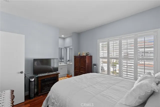 a bedroom with a bed and a television