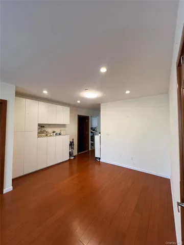 a view of an empty room with a kitchen