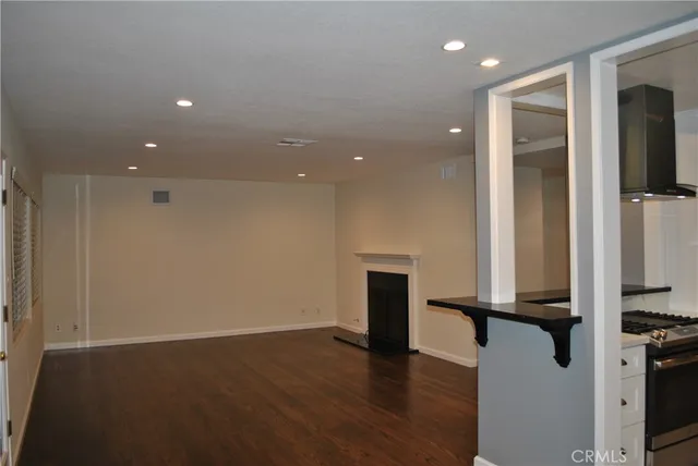 an empty room with wooden floor