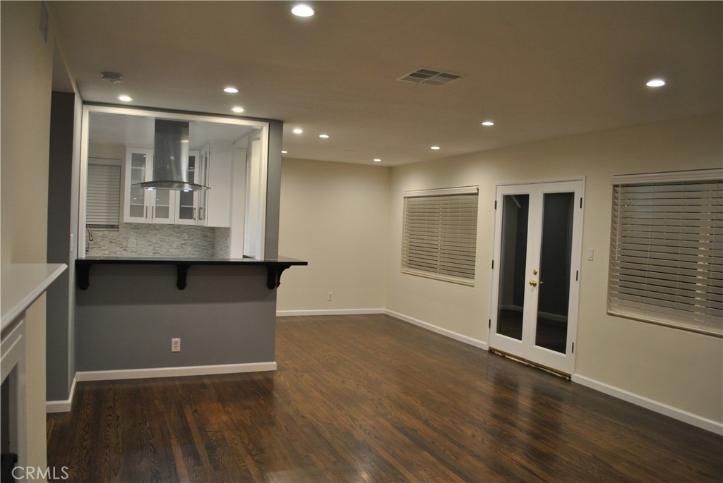 620 Stephen Road Burbank, CA 91504 - Photo 4 of 15 an empty room with wooden floor and windows