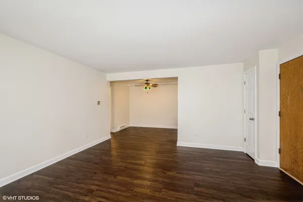 a view of an empty room with wooden floor